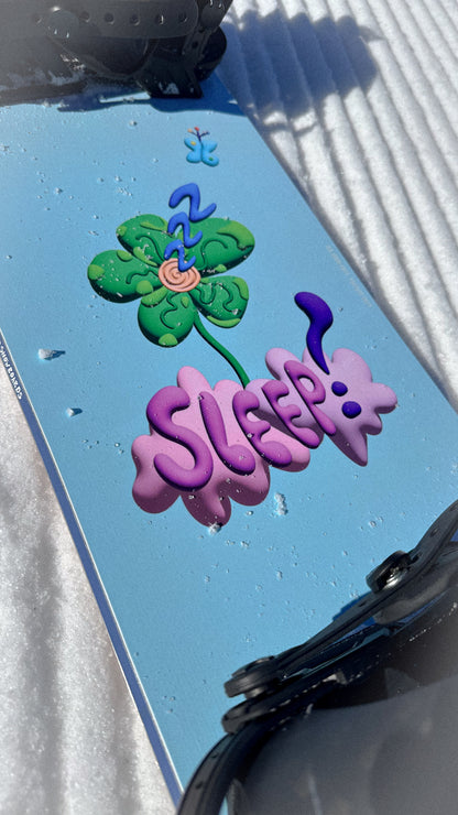 Pink Cloud Pro Mini Snowboard 135 with Sleep Art Design by Ryan Paul on Snowy Terrain